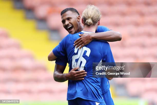 Tom Davies of Everton celebrates with teammate Jose Salomon Rondon after scoring their side's second goal during the Pre-Season Friendly match...