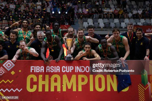 The winner Australia celebrate on the podium with their trophy during the FIBA Asia Cup final between Lebanon and Australia at Istora Gelora Bung...