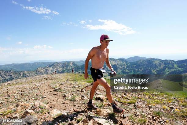 An athlete ascends the summit of Mt. Baldy in the UTMB World Series: 50K Speedgoat Mountain Race on July 23, 2022 in Snowbird, Utah.