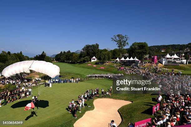 Parachutter lands on the eighteenth hole with the Canadian flag during day four of The Amundi Evian Championship at Evian Resort Golf Club on July...