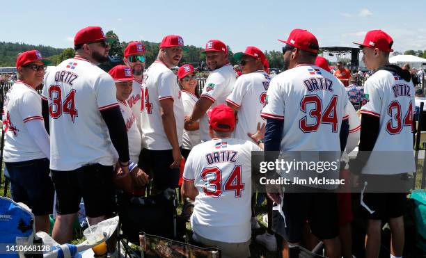 Baseball fans from the Dominican Republic attend the Baseball Hall of Fame induction ceremony in support of inductee David Ortiz at Clark Sports...