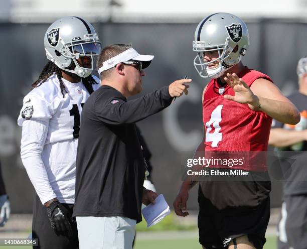 Wide receiver Davante Adams, head coach Josh McDaniels and quarterback Derek Carr of the Las Vegas Raiders talk during training camp at the Las Vegas...