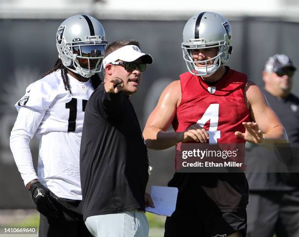 Wide receiver Davante Adams, head coach Josh McDaniels and quarterback Derek Carr of the Las Vegas Raiders talk during training camp at the Las Vegas...