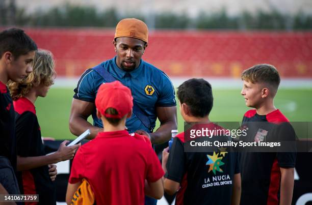 Adama Traore of Wolverhampton Wanderers signs autographs for fans after the pre-season friendly match between Besiktas and Wolverhampton Wanderers at...