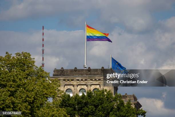 Rainbow flag, symbol of the queer community, flys over the Reichstag, seat of the Bundestag, which was hoisted for the first time by the Bundestag,...