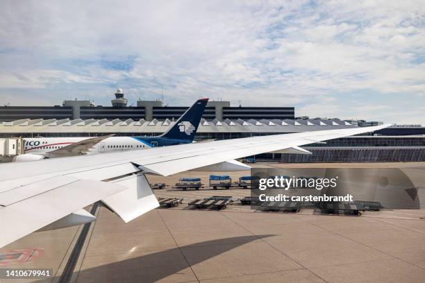 view to an airport terminal and luggage charts on the tarmac - schiphol airport the netherlands stock pictures, royalty-free photos & images