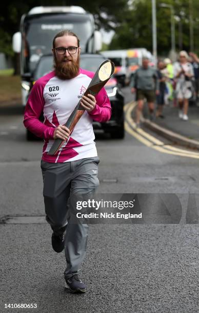 Batonbearer Luke Perigo holds the Queen's Baton during the Birmingham 2022 Queen's Baton Relay on July 24 Wolverhampton, United Kingdom.