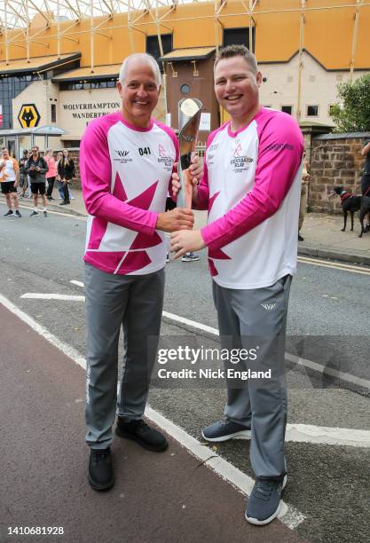 Batonbearers Steve Bull and Adam Strand hold the Queen's Baton during the Birmingham 2022 Queen's Baton Relay on July 24 Wolverhampton, United...