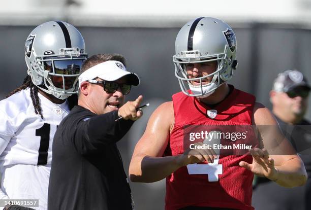 Wide receiver Davante Adams, head coach Josh McDaniels and quarterback Derek Carr of the Las Vegas Raiders talk during training camp at the Las Vegas...