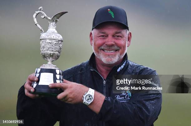 Darren Clarke of Northern Ireland poses with the trophy as he wins the Senior Open Presented by Rolex at The King's Course at Gleneagles on July 24,...