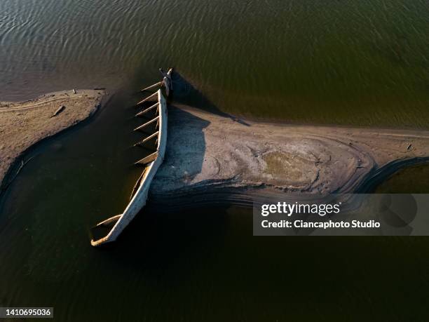 In this aerial view wrecks from the Second World War are seen above the waterline in the Po river on July 24, 2022 in Sermide, Italy.