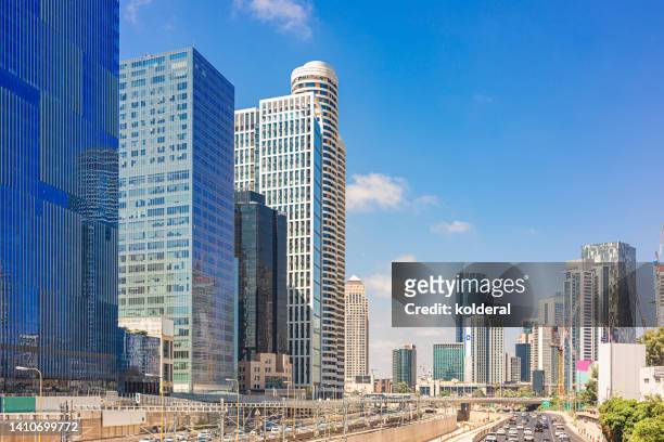 midday in modern city. skyscrapers against blue sky. tel aviv downtown - tel aviv stock pictures, royalty-free photos & images
