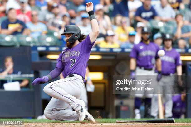 Brendan Rodgers of the Colorado Rockies beats the throw to the plate scoring in the seventh inning against the Milwaukee Brewers at American Family...