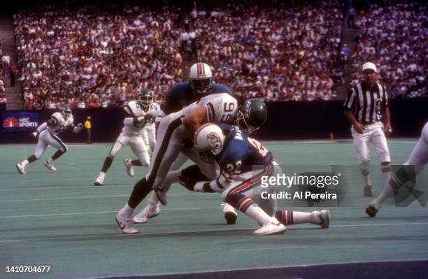 Defensive End Mark Gastineau of the New York Jets rushes at the line in the game between the Miami Dolphins vs New York Jets at The Meadowlands on...