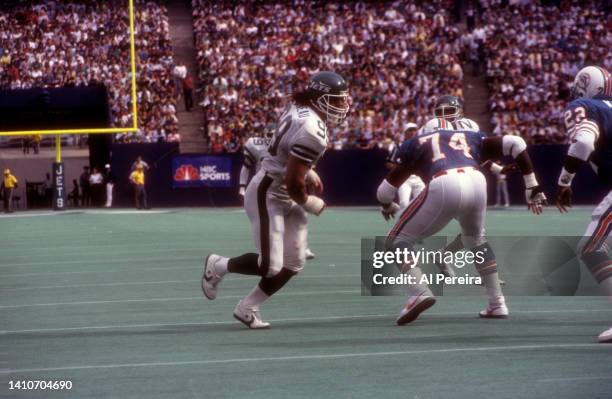 Defensive End Mark Gastineau of the New York Jets rushes at the line in the game between the Miami Dolphins vs New York Jets at The Meadowlands on...