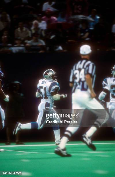 Linebacker Sam Mills of the Carolina Panthers returns an Interception for a Touchdown against the New York Giants in the game between the Carolina...