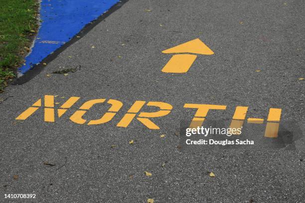 painted sign showing the north location - north arrow stock pictures, royalty-free photos & images