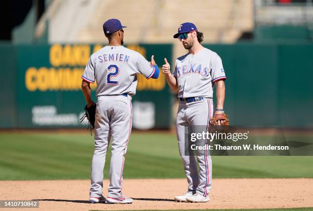 Marcus Semien and Charlie Culberson of the Texas Rangers celebrates defeating the Oakland Athletics 11-8 at RingCentral Coliseum on July 24, 2022 in...