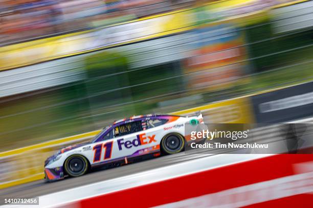 Denny Hamlin, driver of the FedEx Office Toyota, drives during the NASCAR Cup Series M&M's Fan Appreciation 400 at Pocono Raceway on July 24, 2022 in...