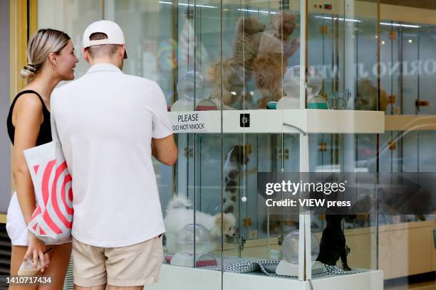 People look puppies displayed at a pet shop on July 24, 2022 in New York. A bill banning the sale of dogs, cats and rabbits in New York pet stores...