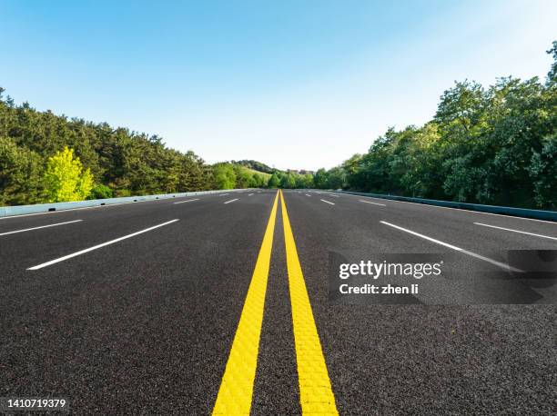 mountain highway through the trees - surface level road stock pictures, royalty-free photos & images