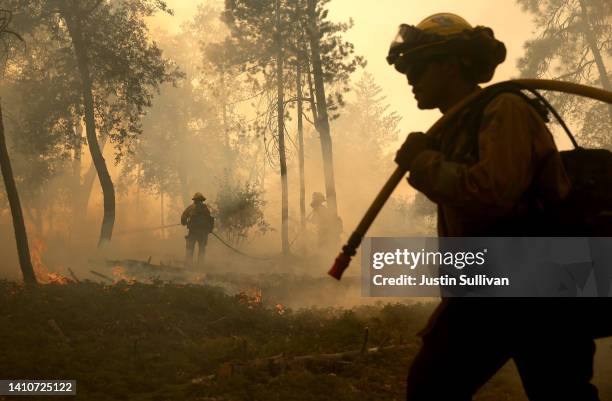 Cal Fire firefighters monitor a burn operation as they battle the Oak Fire on July 24, 2022 near Jerseydale, California. The fast moving Oak Fire...