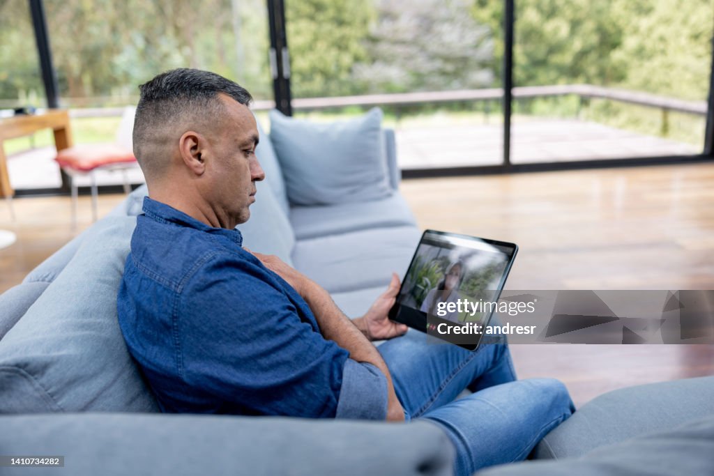 Man At Home Talking A Doctor About His Sore Throat On A Video Call High ...