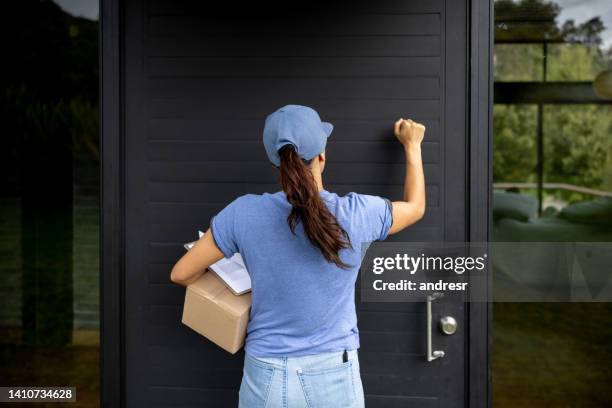 delivery person knocking on the door at a house - knock stock pictures, royalty-free photos & images