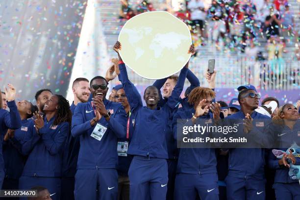 Athing Mu of Team United States holds up the World Team Trophy after Team United States won on day ten of the World Athletics Championships Oregon22...