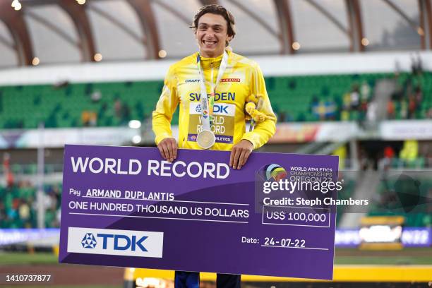 Gold medalist Armand Duplantis of Team Sweden poses with a check for setting the world record during the medal ceremony for the Men's Pole Vault on...