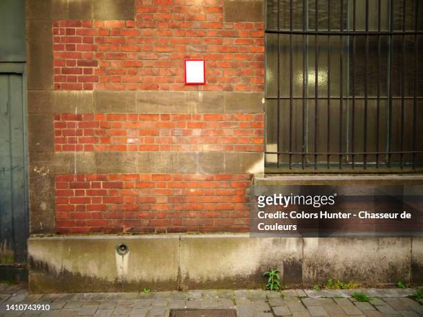old brick and concrete wall with window, and wooden door, cobbled sidewalk and light effect in brussels, belgium - abandon stock pictures, royalty-free photos & images