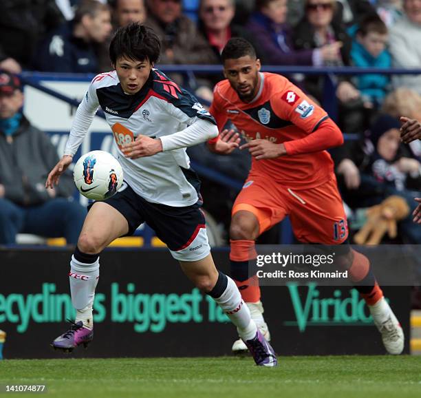 Ryo Miyaichi of Bolton is challenged by Armand Traore of QPR during the Barclays Premiership match between Bolton Wanderers and Queens Park Rangers...