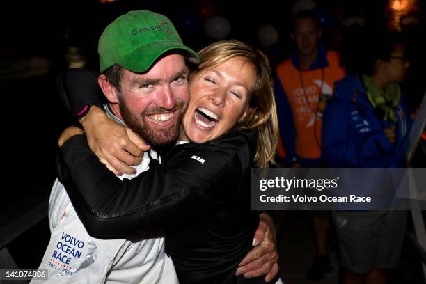 Brad Marsh from New Zealand is greeted by his girlfriend, Team Sanya rigger Robin Hilton, as Groupama Sailing Team finish first in to Auckland...