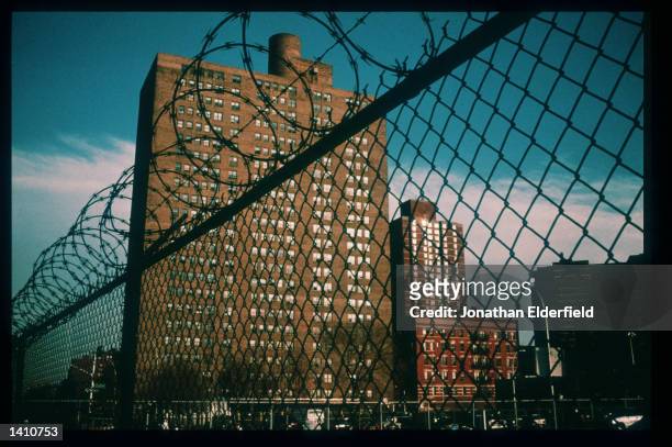 Razor wire fence stands near a housing project in the East Village June 1, 1998 in New York City. Populated by residents of numerous heritages...