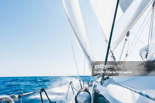 sun shining from behind the sails of a yacht. - sail ship stock pictures, royalty-free photos & images