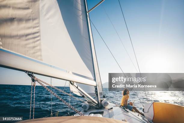 caucasian man sitting on yacht deck. - sailing competition stock pictures, royalty-free photos & images