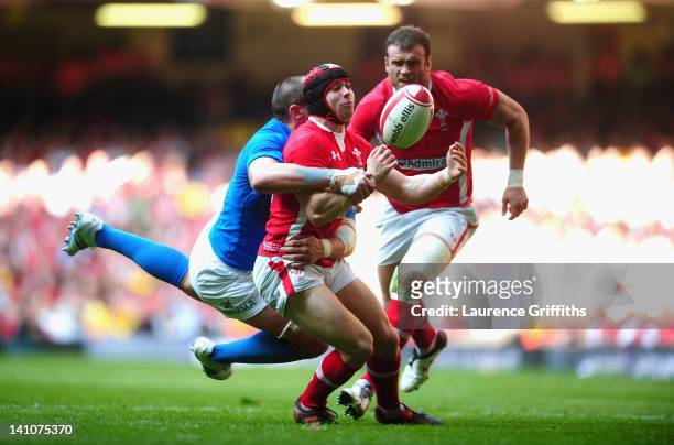Leigh Halfpenny of Wales is tackled by Sergio Parisse of Italy during the RBS Six Nations match between Wales and Italy at Millenium Stadium on March...