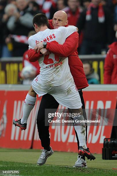 Christian Clemens of Cologne celebrates with head coach Stale Solbakken after scoring his team's first goal during the Bundesliga match between 1. FC...