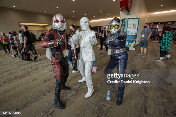 Marvel cosplayers Joshua Kerns as Ant-Man, Andre Rhoden as Mr. Knight, and Betty Rodriguez as The Wasp pose for photos during 2022 Comic-Con...