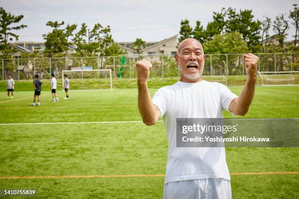 portrait of senior playing soccer - punching the air stock pictures, royalty-free photos & images