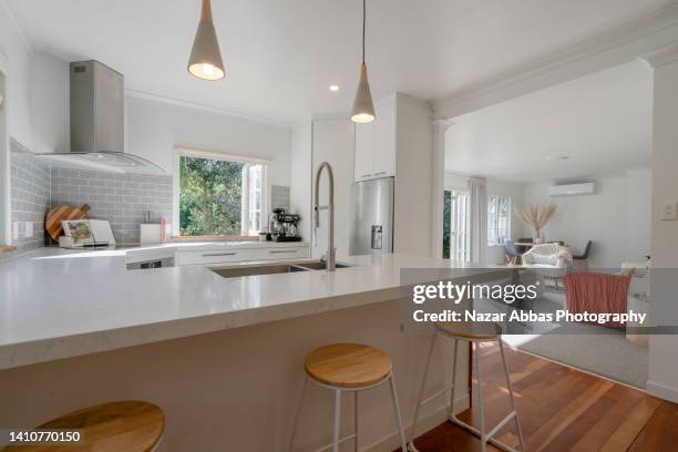 view of kitchen and living room in new luxury home. - kitchen island stock pictures, royalty-free photos & images