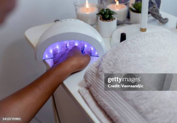 close up of female hands having manicure treatment - drying stock pictures, royalty-free photos & images