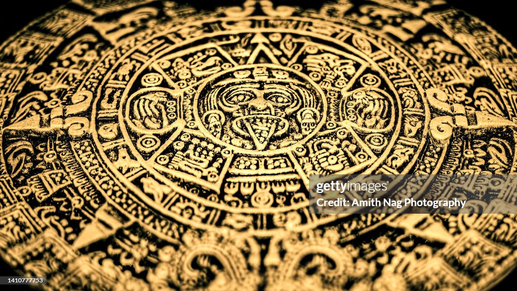 An Aztec or Incan or Mayan gold coin featuring Mayan calendar