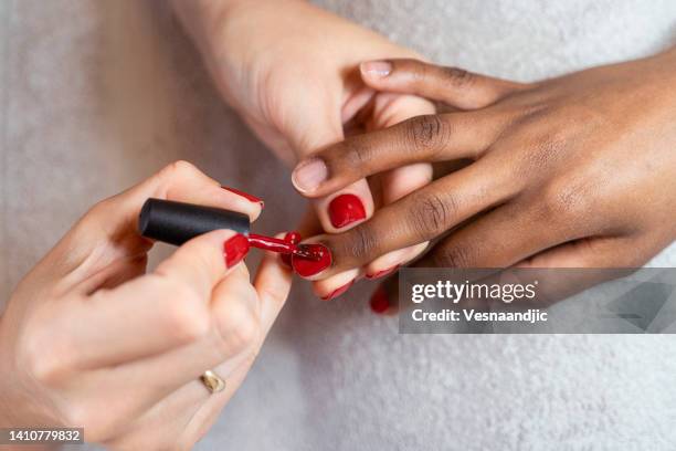 close up of female hands having manicure treatment - african american nails stock pictures, royalty-free photos & images