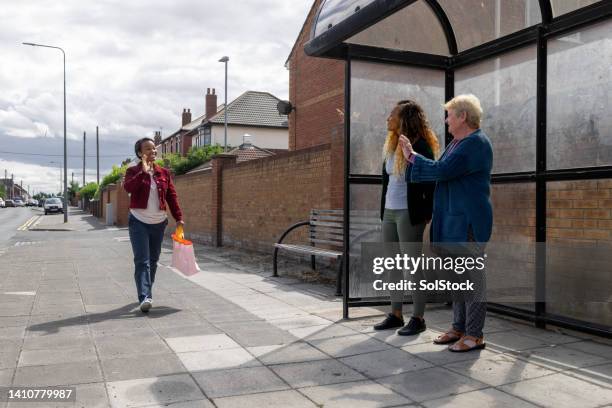 on a journey with family - female waving on street stock pictures, royalty-free photos & images