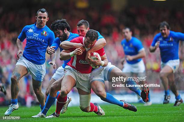 Jamie Roberts of Wales is tackled by Alberto Sgarbi of Italy during the RBS Six Nations match between Wales and Italy at Millenium Stadium on March...