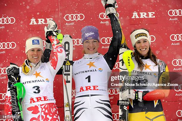 Maria Hoefl-Riesch of Germany takes 1st place, Veronika Zuzulova of Slovakia takes 2nd place, Marie-Michele Gagnon of Canada takes 3rd place during...