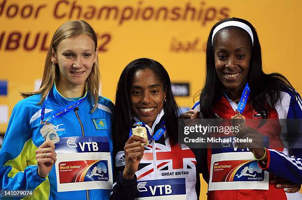 Silver medalist Olga Rypakova of Kazakhstan, gold medalist Yamile Aldama of Great Britain and bronze medal Mabel Gay of Cuba stand on the podium...