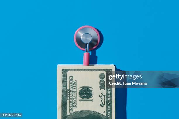 stethoscope and us dollars - expense stock pictures, royalty-free photos & images