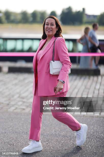 Martina Buckenmaier wearing a pink matching Riani suit and attends the Riani Fashion Festival on July 23, 2022 in Dusseldorf, Germany.